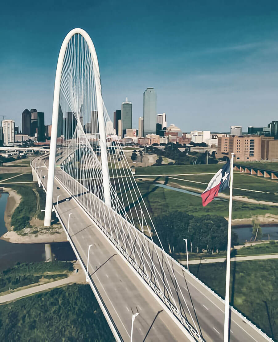 Margaret Hunt Hill bridge in front of Dallas skyline